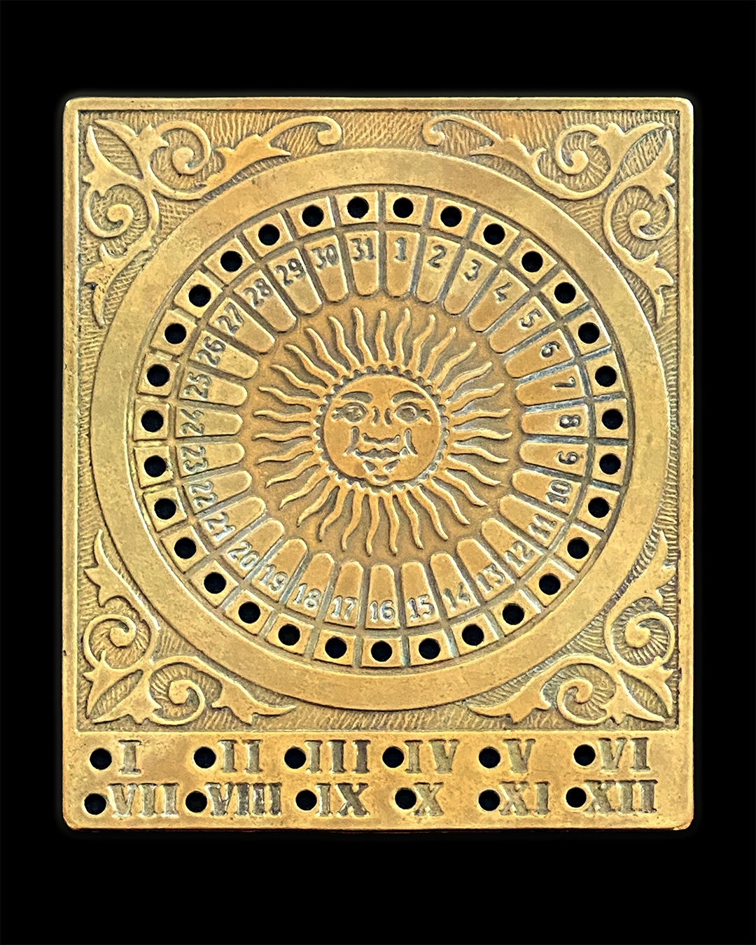 Brass perpetual calendar with sun motif in the center